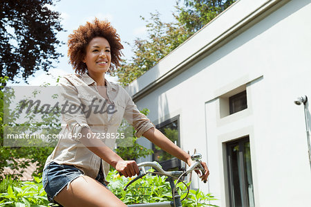 Woman riding bicycle, low angle