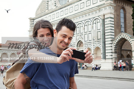 Young couple outside Santa Maria Novella church, Florence, Tuscany, Italy