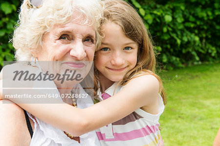 Portrait of grandmother and granddaughter hugging