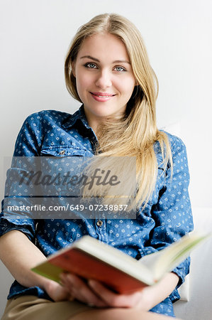 Girl looking up from book Girl looking up from book