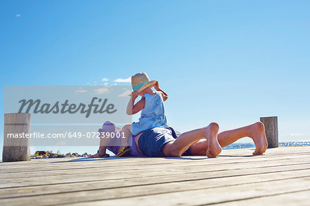 Female toddler and father on jetty, Utvalnas, Gavle, Sweden