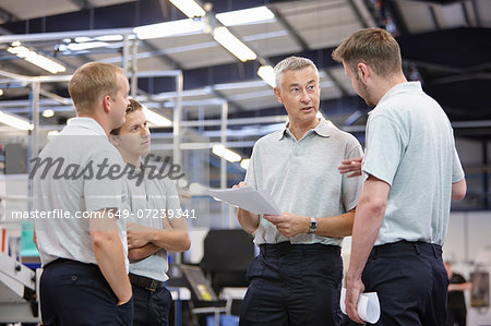 Workers meeting in engineering factory