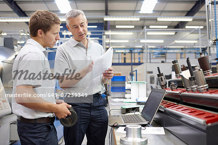 Worker and manager meeting in engineering warehouse