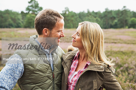 Mid adult couple smiling face to face