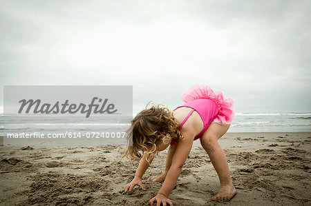 Female toddler playing with sand