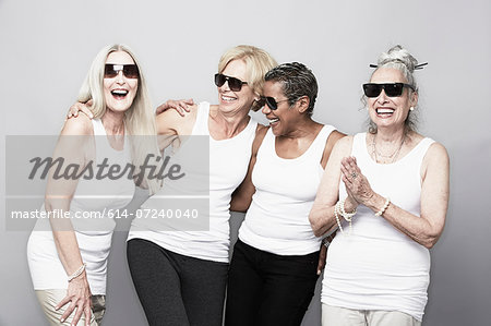 Studio portrait of senior women friends in sunglasses