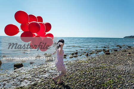 Mature woman pulling bunch of balloons Mature woman pulling bunch of balloons