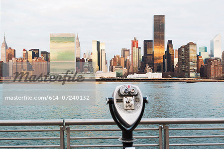 View of tourist binoculars toward East River and manhattan skyline, New York, USA