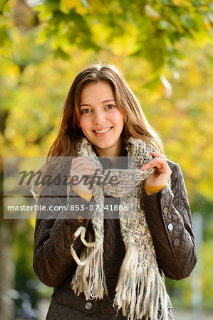 Smiling young woman in autumn, portrait