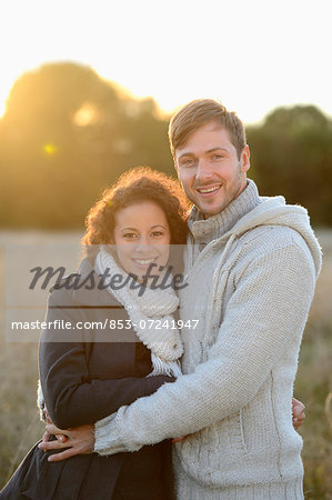 Smiling couple hugging in autumn