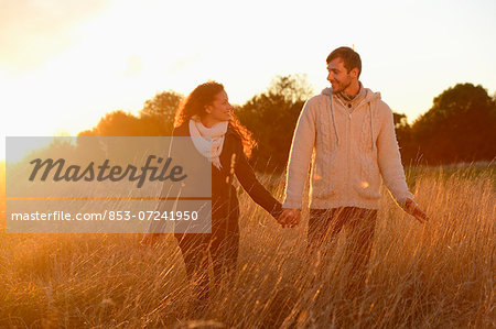 Smiling couple in field in autumn