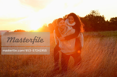 Smiling couple in field in autumn