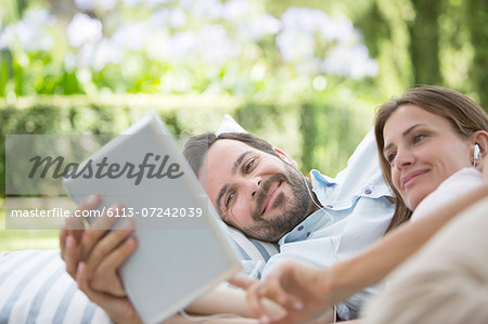 Couple using digital tablet outdoors