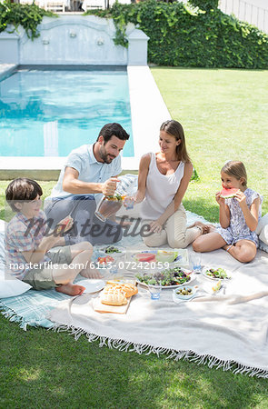 Family enjoying picnic in backyard