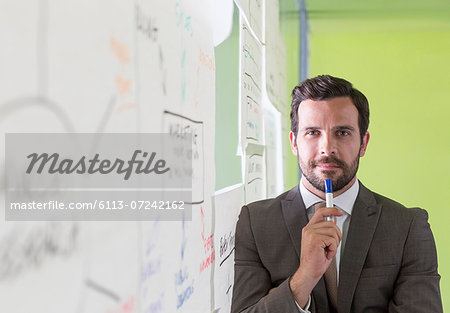 Businessman thinking at glass wall