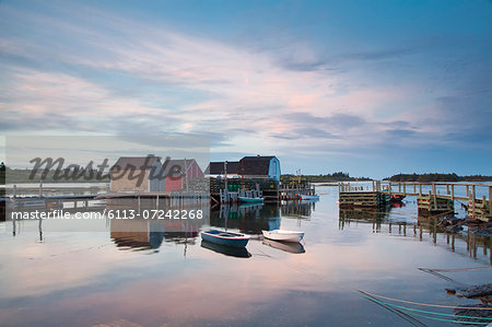 Rowboats and buildings on calm bay