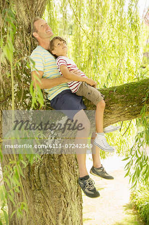 Father and son relaxing in tree