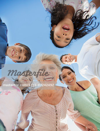 Multi-generation family smiling in huddle