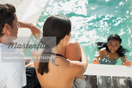 Family relaxing at swimming pool