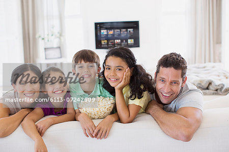 Family relaxing together on sofa in living room