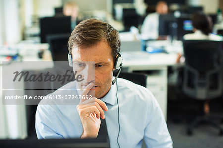 Businessman wearing headset in office