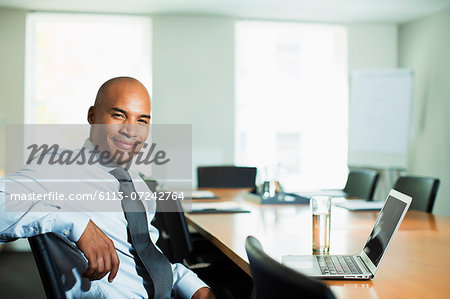 Businessman smiling at conference table