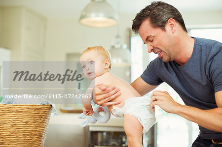 Father checking baby's diaper