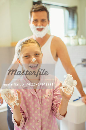 Father and daughter playing with shaving cream