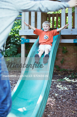 Father catching son on slide