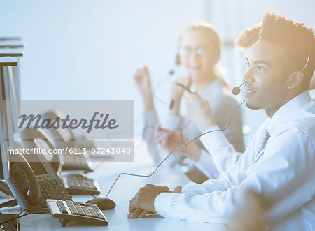 Businessman talking on headset in office