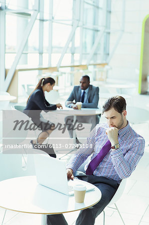 Business people working in office lobby