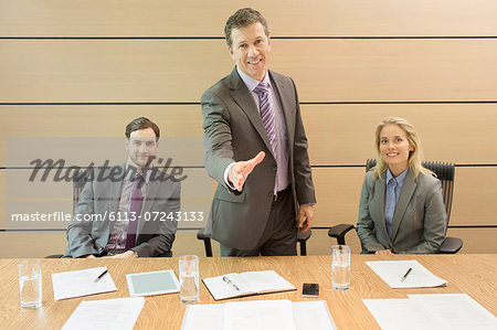 Businessman extending handshake in meeting