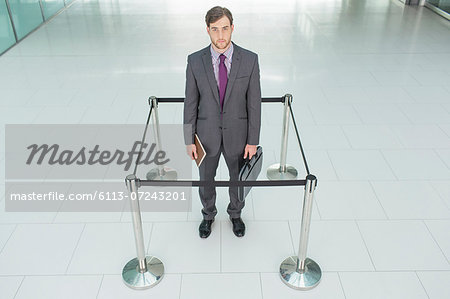 Businessman standing in roped-off square