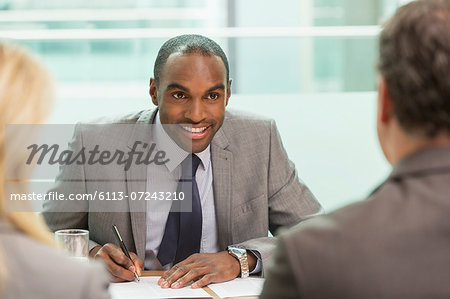 Businessman taking notes in meeting