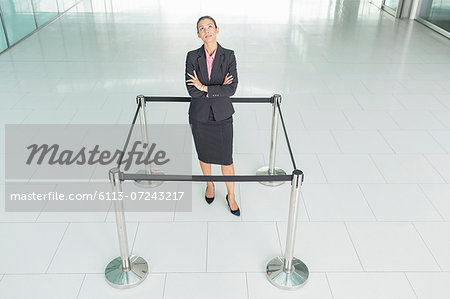 Businesswoman standing in roped-off square