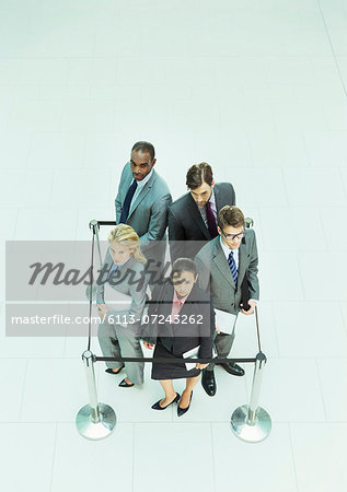 Business people standing in roped-off square