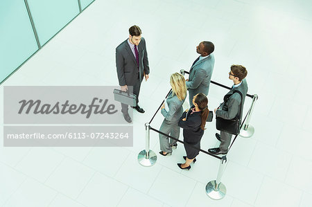 Businessman standing outside roped-off square