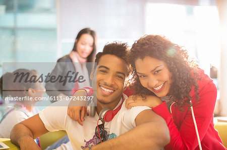 Young couple smiling in student lounge