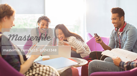 University students using technology in lounge
