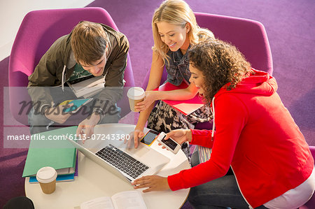 University students using laptop in lounge