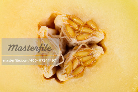 Macro photo of yellow melon seeds inside the fruit