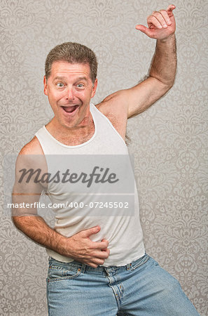 Dancing Caucasian man in blue jeans and undershirt