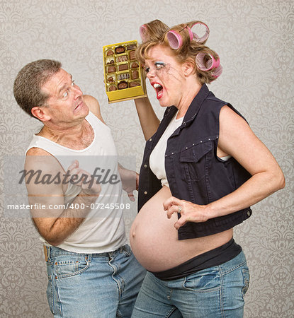 Angry pregnant hillbilly woman yelling at man with chocolate