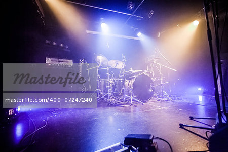 Drumkit on empty stage waiting for musicians (logo removed)