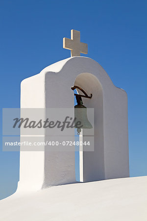 The white bell tower of a typical Greek church