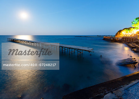 Ruined pier, Moon Path and evening summer coastline (Bulgaria).