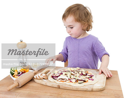 preschooler making fresh pizza on wooden desk. isolated on white background