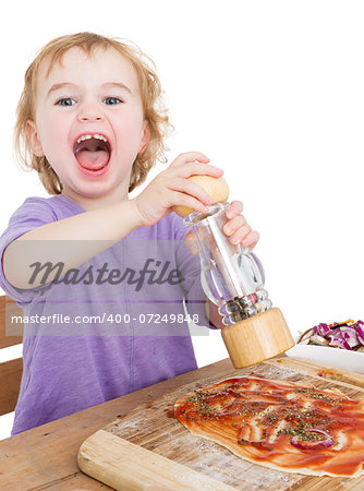 child with pepper making fresh pizza. studio shot isolated on white background