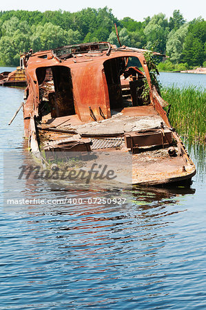 Wrecked abandoned ship on a river after nuclear disaster in Chernobyl, Ukraine