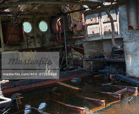 Wrecked abandoned ship interior on a river after nuclear disaster in Chernobyl, Ukraine